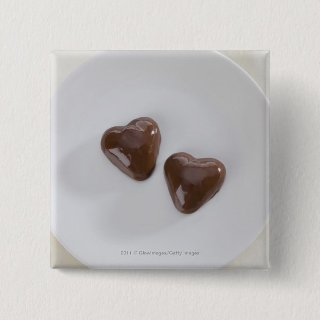 Heart shaped chocolate candies on a plate pinback button (Front)