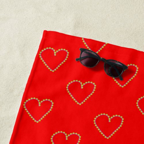 Heart shaped hearts on red beach towel