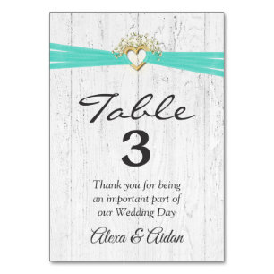 Heart with Turquoise Ribbon On Whitewashed Wood Table Number
