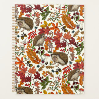 Hedgehogs and autumn forest flora on ivory planner