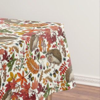 Hedgehogs and autumn forest flora on ivory tablecloth