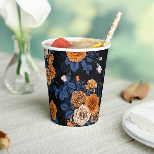 Hidden in the roses orange and blue paper cups