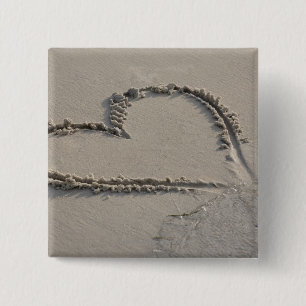 High angle view of a heart shape on the beach button