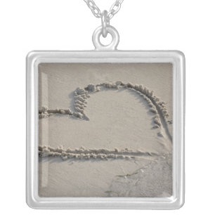High angle view of a heart shape on the beach silver plated necklace