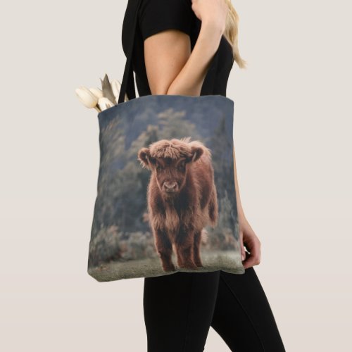 Highland cow calf autumn grass field tote bag