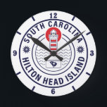 Hilton Head Island Lighthouse Retro Sunset Round Clock<br><div class="desc">Hilton Head Home beach design for vacation. Hilton Head South Carolina island Vintage souvenir for travel to South Carolina island. Hilton Head beach artwork for South Carolina vacationers and backpackers. Hilton Head retro souvenir. Design for backpackers and travel to South Carolina . island with beach Vintage souvenir for seaside vacationers....</div>
