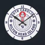 Hilton Head Island Lighthouse Retro Sunset Round Clock<br><div class="desc">Hilton Head Home beach design for vacation. Hilton Head South Carolina island Vintage souvenir for travel to South Carolina island. Hilton Head beach artwork for South Carolina vacationers and backpackers. Hilton Head retro souvenir. Design for backpackers and travel to South Carolina . island with beach Vintage souvenir for seaside vacationers....</div>