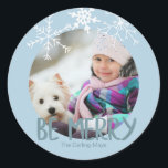Holiday Photo Be Merry Christmas Blue Snowflakes Classic Round Sticker<br><div class="desc">The sticker has a placeholder for you to add your own photo. The typography is designed as a photo overlay and reads "Be Merry" in a modern font. You can further personalize the design by adding your family name(s). The sticker is powder blue with soft white, hand drawn snowflakes. Matching...</div>