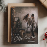 Holiday Photo Card | Modern Trendy Christmas<br><div class="desc">Share your holiday joy with this modern and trendy Christmas photo card featuring your favourite couple photo. The design combines elegant handwritten script with bold modern typography in white over a full photo background, softened with a black faded tint. The back of the card features a deep smoky green gray...</div>