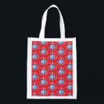 Holiday red and blue snowflakes and stars reusable grocery bag<br><div class="desc">Holiday red and blue snowflakes and stars pattern. 
Need more? Check out other holiday designs at my store! Cheers! :)</div>