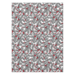 Holly berry, gray leaves on white tablecloth