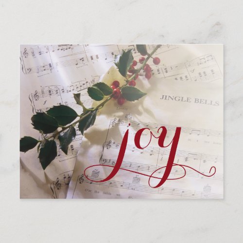 Holly branch on top of sheet music for Christmas Holiday Postcard