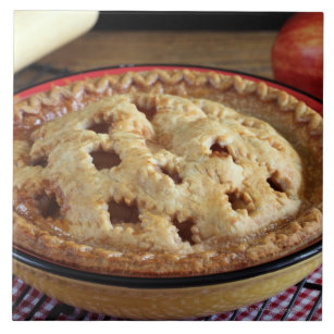 Home baked apple pie on cooling rack with apple ceramic tile