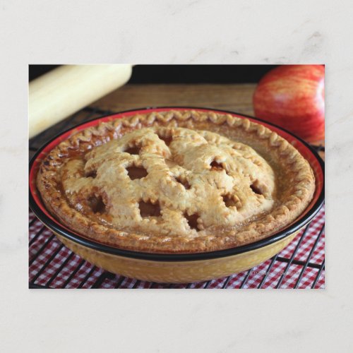 Home baked apple pie on cooling rack with apple postcard