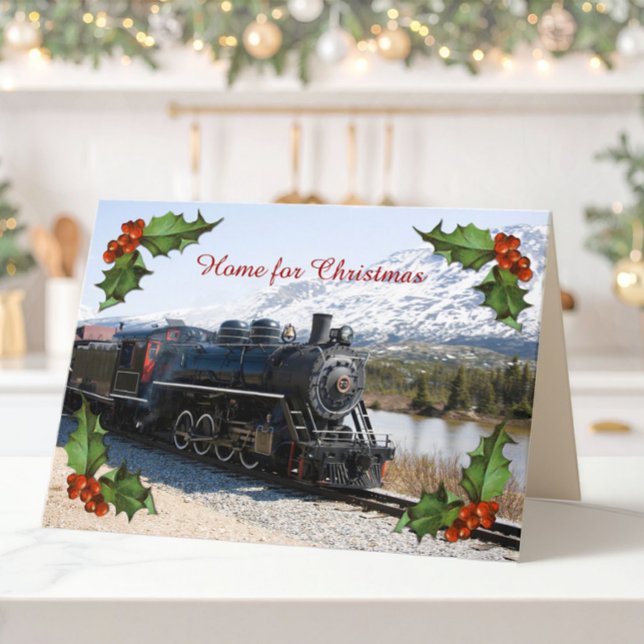 Home on the Train for Christmas Card (A folded Christmas card of an old steam train, snowy mountains and corner decorations of holly.)