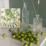 Honeybee Haven Ceramic Tile<br><div class="desc">Transform your space with the enchanting Honeybee Haven Ceramic Tile. This exquisite piece features a vintage-inspired design of buzzing bees and vibrant wildflowers, capturing the essence of nature's beauty. The high-quality ceramic construction and glossy finish ensure both durability and a touch of elegance. Perfect for creating a stunning backsplash, adding...</div>