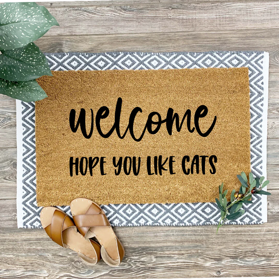 Personalized welcome mat with message in bold lettering. A perfect doormat for cat lovers' homes.