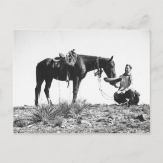 Horse eating from a cowboy's hat. postcard