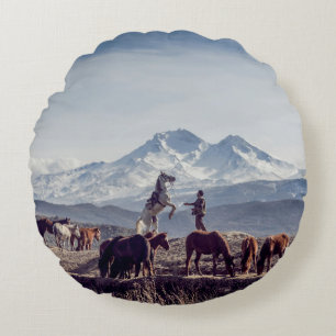 HORSES IN BROWN OPEN FIELD VIEWING MOUNTAIN AT DAY ROUND PILLOW