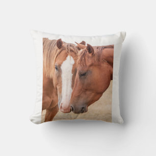 Horses nuzzling in a pasture throw pillow