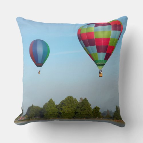 Hot air balloons over a lake  NZ Throw Pillow