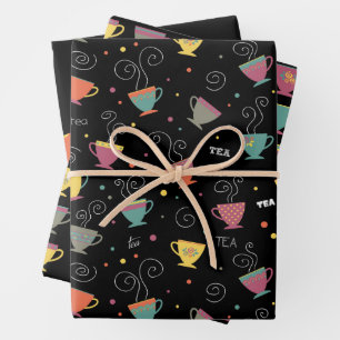 Hot cup of tea, colorful coffee mugs steaming wrapping paper sheets