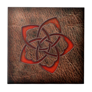 Hot orange celtic flower on leather tile