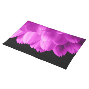 Hot pink flower petals on black cloth placemat