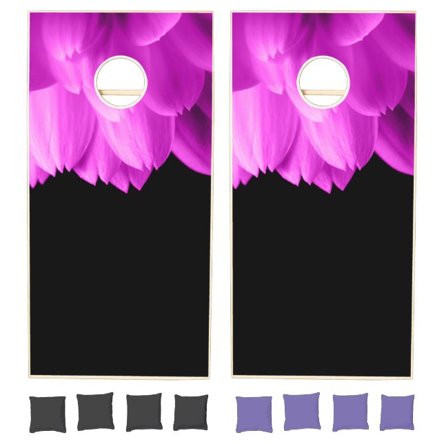 Hot pink flower petals on black cornhole set (Set)