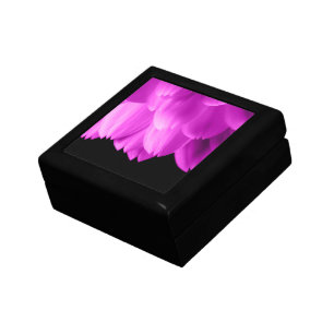 Hot pink flower petals on black gift box