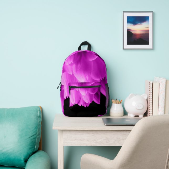 Hot pink flower petals on black printed backpack (Insitu)