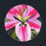 Hot pink lily Tenerife pop art watercolor flower Round Clock<br><div class="desc">with original design from watercolour painting by artist Sacha Grossel of hot pink lily flower in close up, pop art macro style. This botanical inspired floral design is very bright and colourful with intense pink petals and green background.</div>
