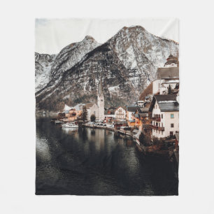 HOUSES NEAR BODY OF WATER AND MOUNTAIN FLEECE BLANKET