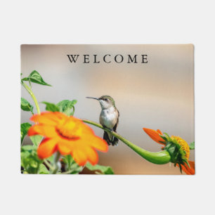 Hummingbird on a flowering plant doormat