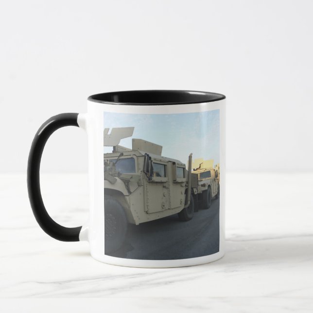 Humvees sit on the pier at Morehead City Mug (Left)