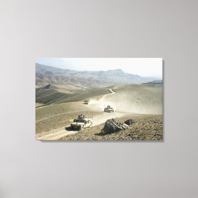 Humvees traverse rugged mountain roads canvas print (Front)