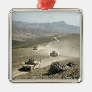 Humvees traverse rugged mountain roads metal ornament