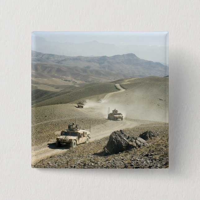 Humvees traverse rugged mountain roads pinback button (Front)