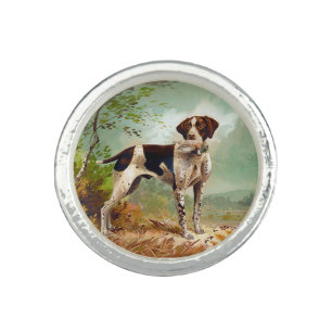Hunter dog with bird in mouth ring