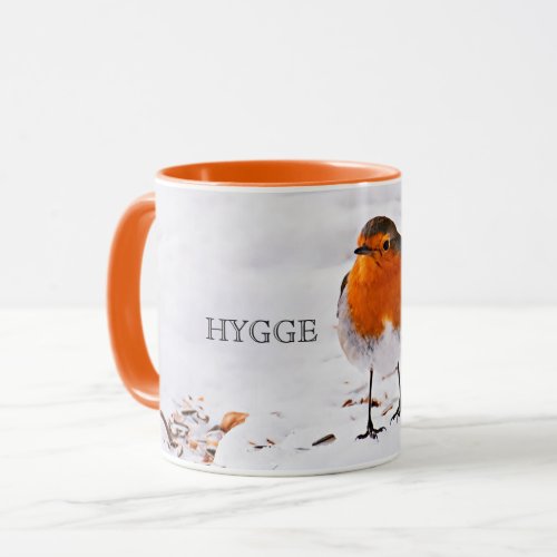 Hygge with a cute robin bird in snow mug