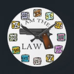 I Am the Law Gun  Round Clock<br><div class="desc">This bold and striking clock design features a powerful handgun integrated into the clock hands, making a strong statement about authority and justice. The words “I AM THE LAW” stand prominently against a clean white background, surrounded by colorful Roman numerals that add a unique artistic contrast. Perfect for those who...</div>