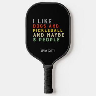 I like dogs and Pickleball and may be 3 people  Pickleball Paddle