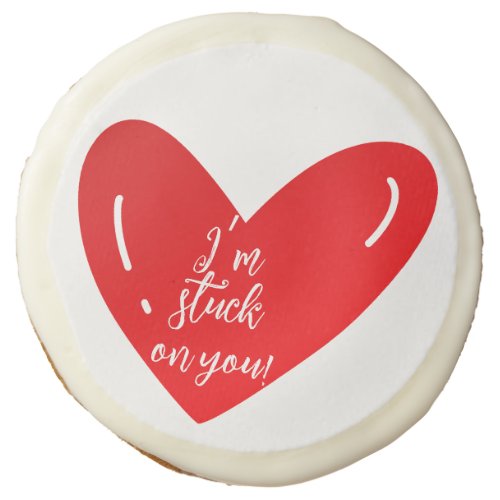 Im stuck on you message on a red heart shape sugar cookie