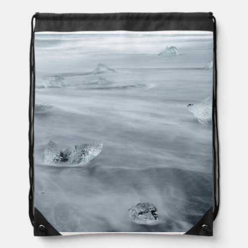 Ice and water on a beach iceland drawstring bag