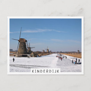 Ice skating along the windmills in winter postcard