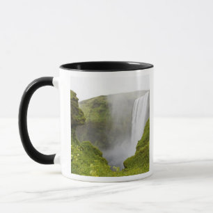 Iceland. Skogarfoss Waterfall plunges over a Mug