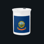 Idaho Flag: the Gem State, America Mountain West Beverage Pitcher<br><div class="desc">The Idaho state flag, a simple yet powerful emblem, was officially adopted in 1907. Its design, a field of blue emblazoned with the state seal, reflects the state's natural beauty and rich history. The blue field symbolizes the vast skies and abundant water resources that characterize Idaho. - At the heart...</div>