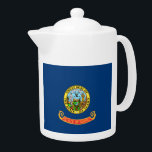 Idaho State Flag Teapot<br><div class="desc">The flag of the state of Idaho consists of the state seal on a field of blue. The words “State of Idaho” appear in gold letters on a red and gold band below the seal. According to the official description of the flag, there should also be a fringe of gold...</div>