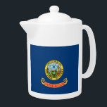 Idaho State Flag Teapot<br><div class="desc">The flag of the state of Idaho consists of the state seal on a field of blue. The words “State of Idaho” appear in gold letters on a red and gold band below the seal. According to the official description of the flag, there should also be a fringe of gold...</div>
