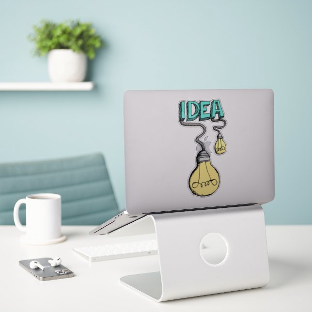 IDEA Spark Sticker – Creativity Plugged In (Laptop On Desk)